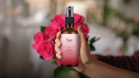 Woman holding Kiyo Beauty Pure Rose Water for Face bottle in front of fresh roses